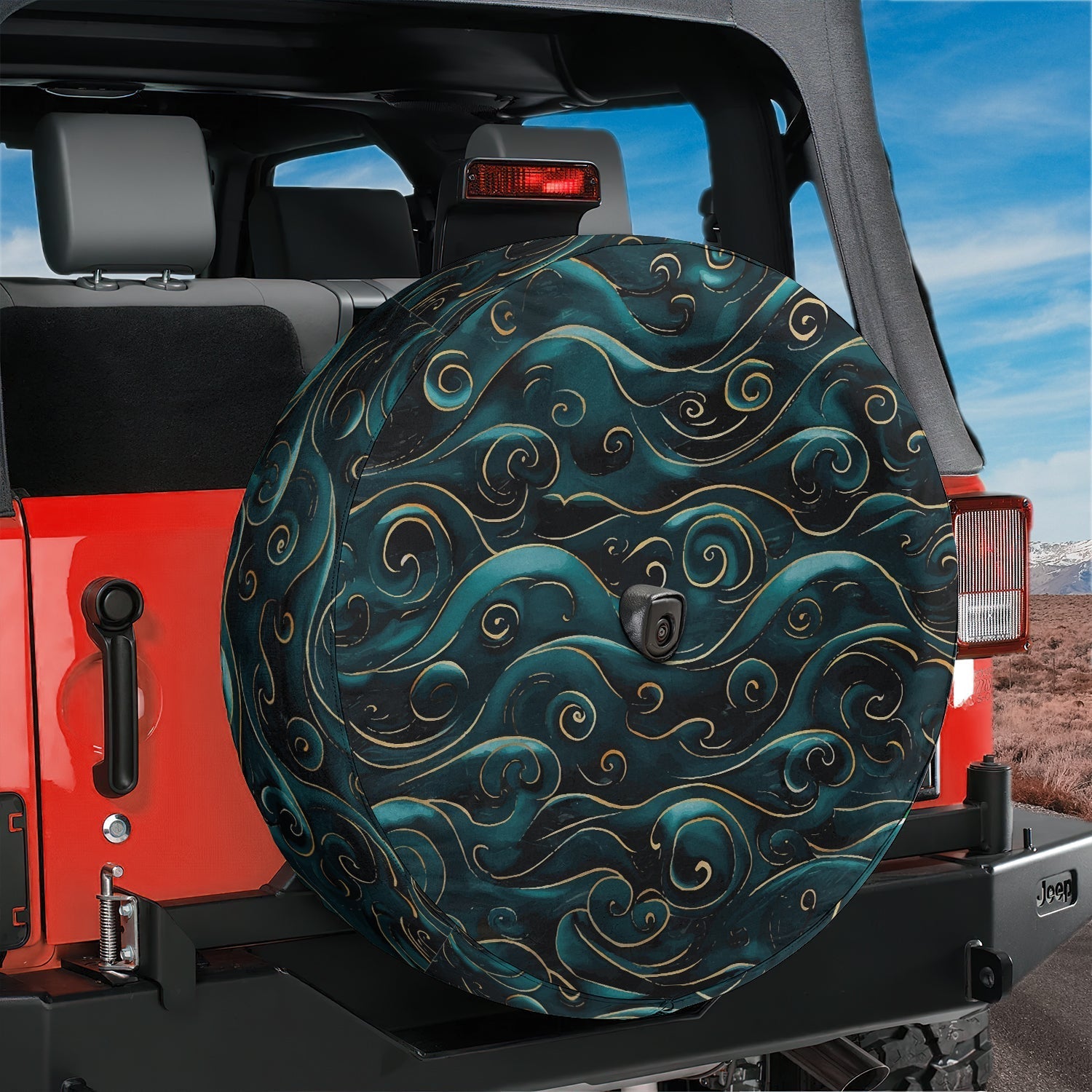 Golden teal waves tire cover on a red Jeep Wrangler with stylized water curls and backup camera hole