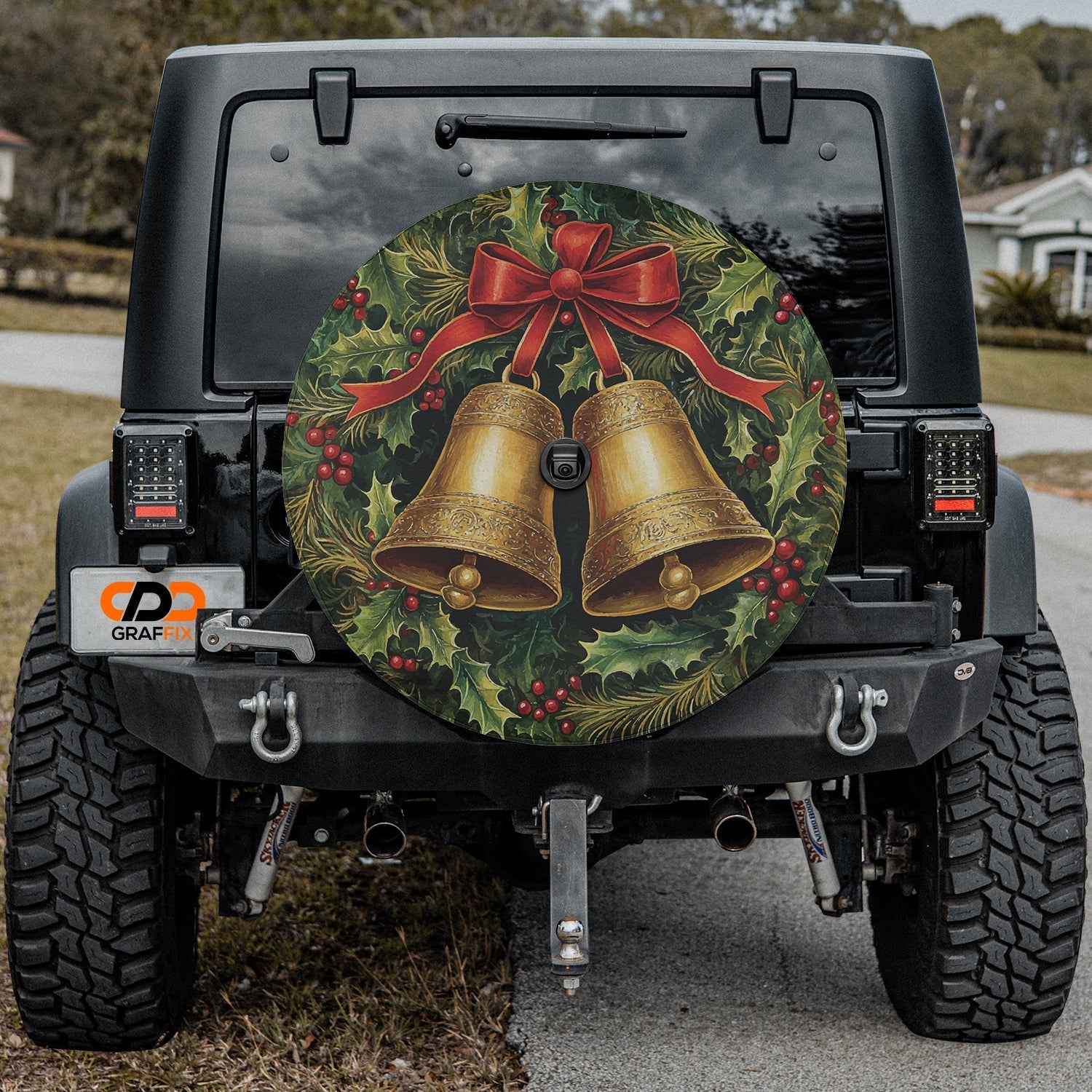 Festive wreath and golden bells spare tire cover mounted on a Jeep showing holiday holly accents