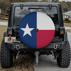 Texas state flag spare tire cover on red Jeep Wrangler with desert backdrop featuring Lone Star design