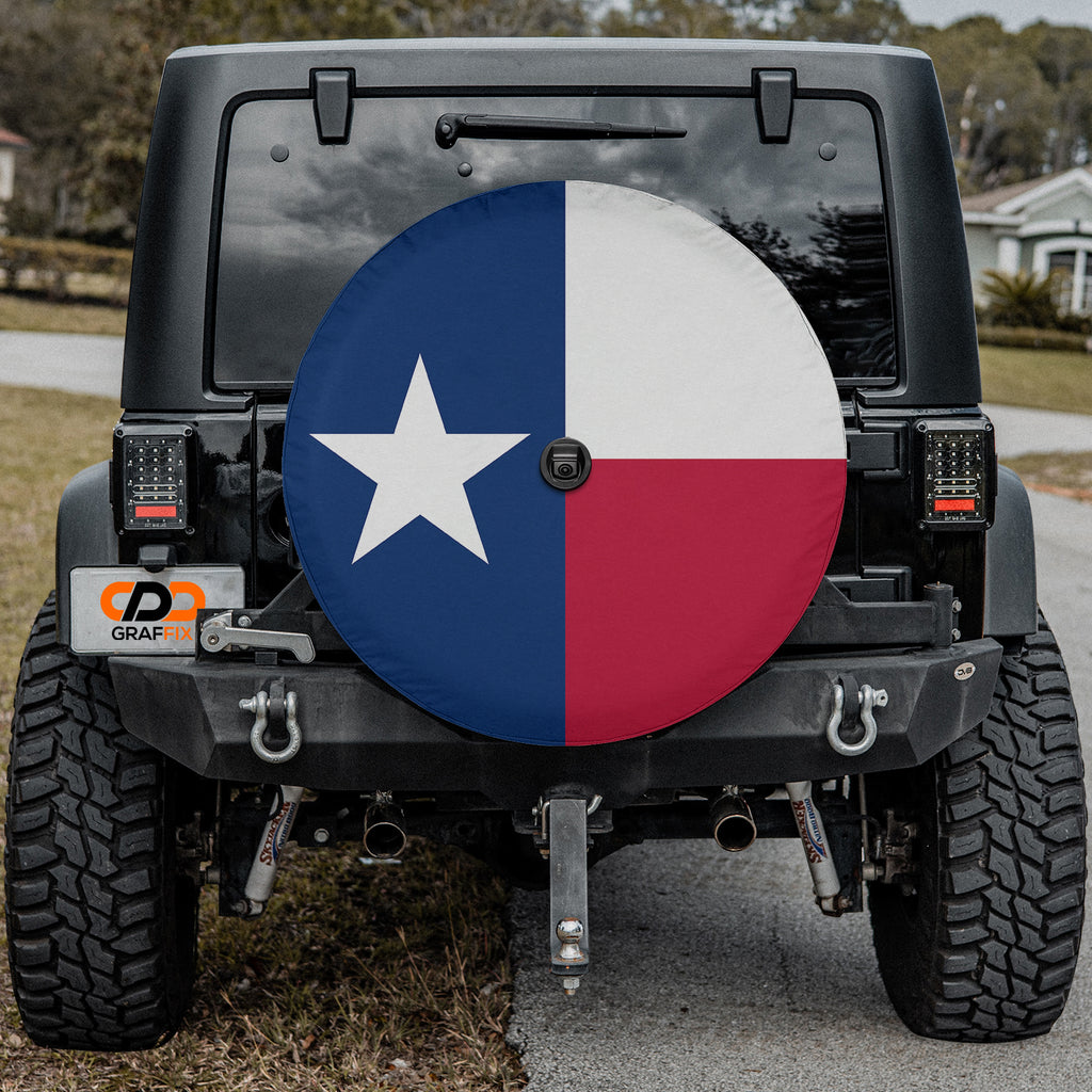 Texas state flag spare tire cover close-up on red Jeep Wrangler showing crisp Lone Star detail in desert setting
