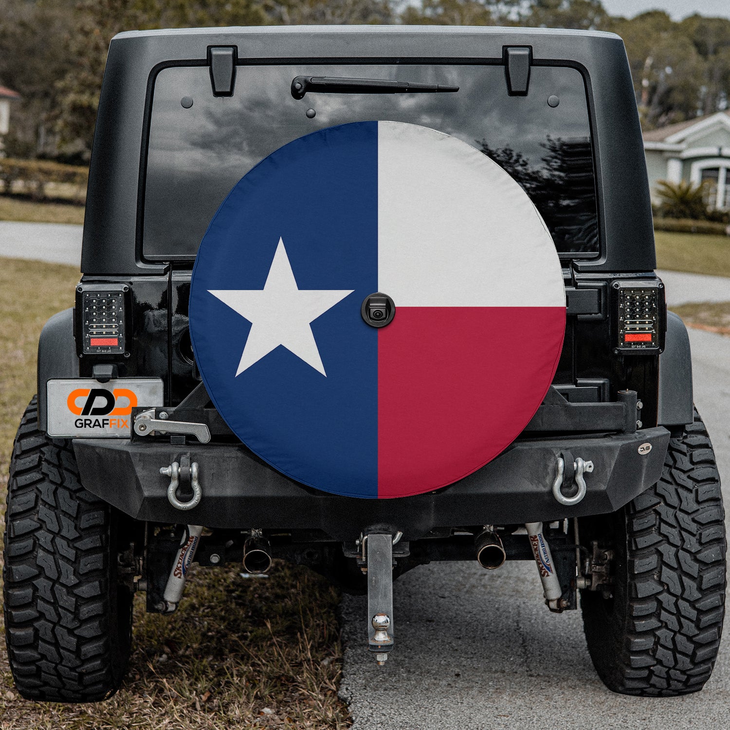 Texas state flag spare tire cover close-up on red Jeep Wrangler showing crisp Lone Star detail in desert setting