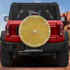 Lemon fruit spare tire cover with yellow citrus slice graphic and juicy sliced lemon design