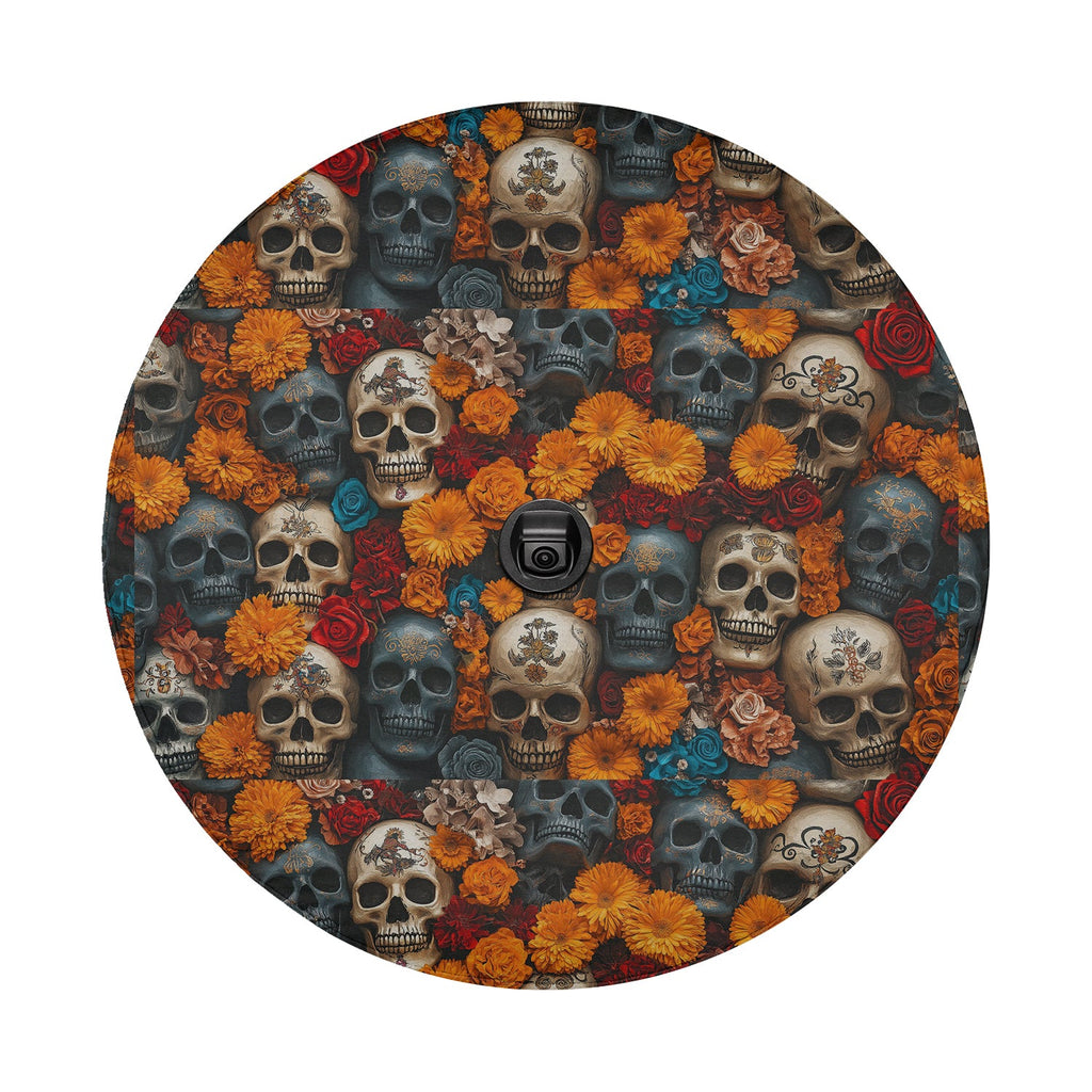 Flowers and skulls tire cover flat round front with marigold blooms, red roses, and stacked aged skull pile