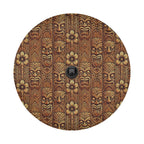 Tiki wood mask spare tire cover with carved Polynesian tiki faces and tropical flowers in warm brown tones