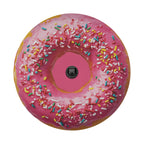 A large pink donut with colorful sprinkles and a black camera lens in the center.