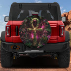a red Jeep Wrangler with a large, colorful wheel cover on the back.