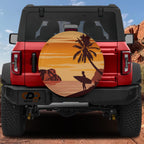 Sunset surfer tire cover front close-up showing tropical beach scene with palm tree and lone surfer silhouette