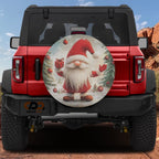 Christmas gift giving gnome spare tire cover mounted on red Bronco with red hat snowflake design