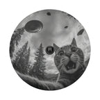 A black and white image of a cat with wide-open eyes and an expression of surprise, surrounded by trees and flying saucers in the sky.