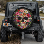 a black Jeep Wrangler with a colorful skull-shaped spare tire cover on the rear of the vehicle.