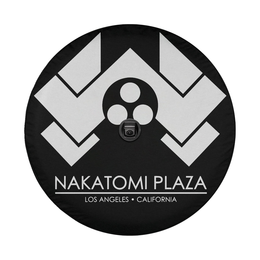 Flat Nakatomi Plaza Los Angeles spare tire cover artwork with white chevron logo on a black circular canvas