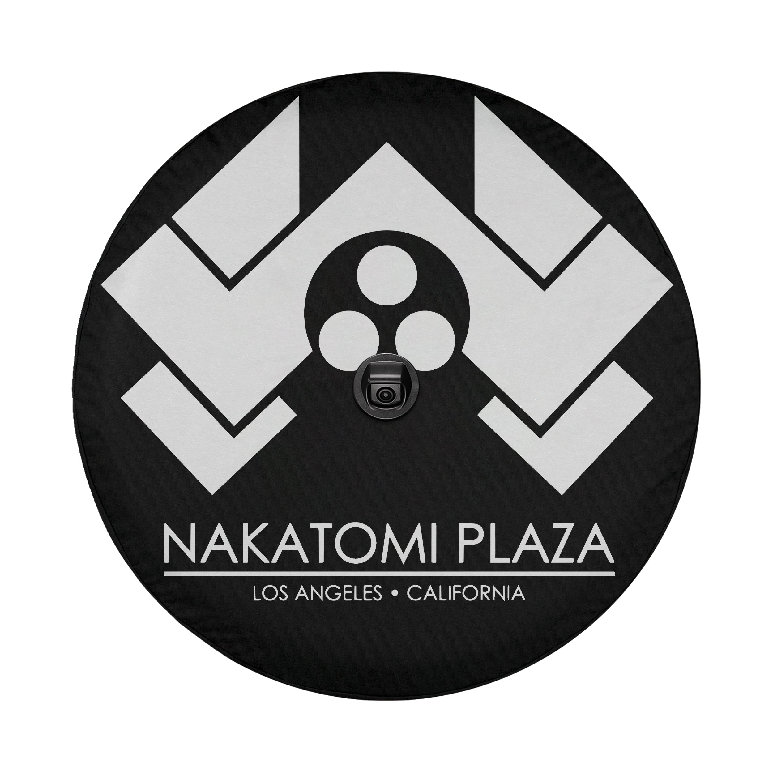Flat Nakatomi Plaza Los Angeles spare tire cover artwork with white chevron logo on a black circular canvas