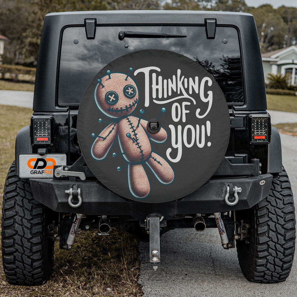 Voodoo doll spare tire cover shown mounted on rear of Jeep vehicle