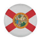 Florida state flag spare tire cover on red Jeep Wrangler with desert backdrop showing red diagonal cross and seal