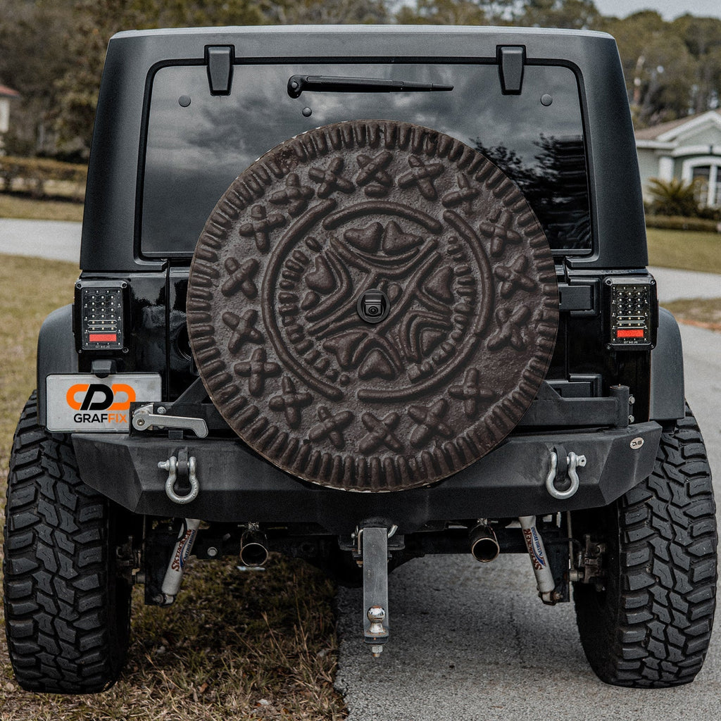 Choco Creme Cookie spare tire cover on a Jeep rear wheel with the playful sandwich cookie design centered on canvas