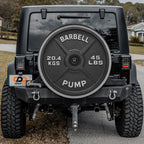 a black Jeep Wrangler with a large barbell attached to the rear of the vehicle.