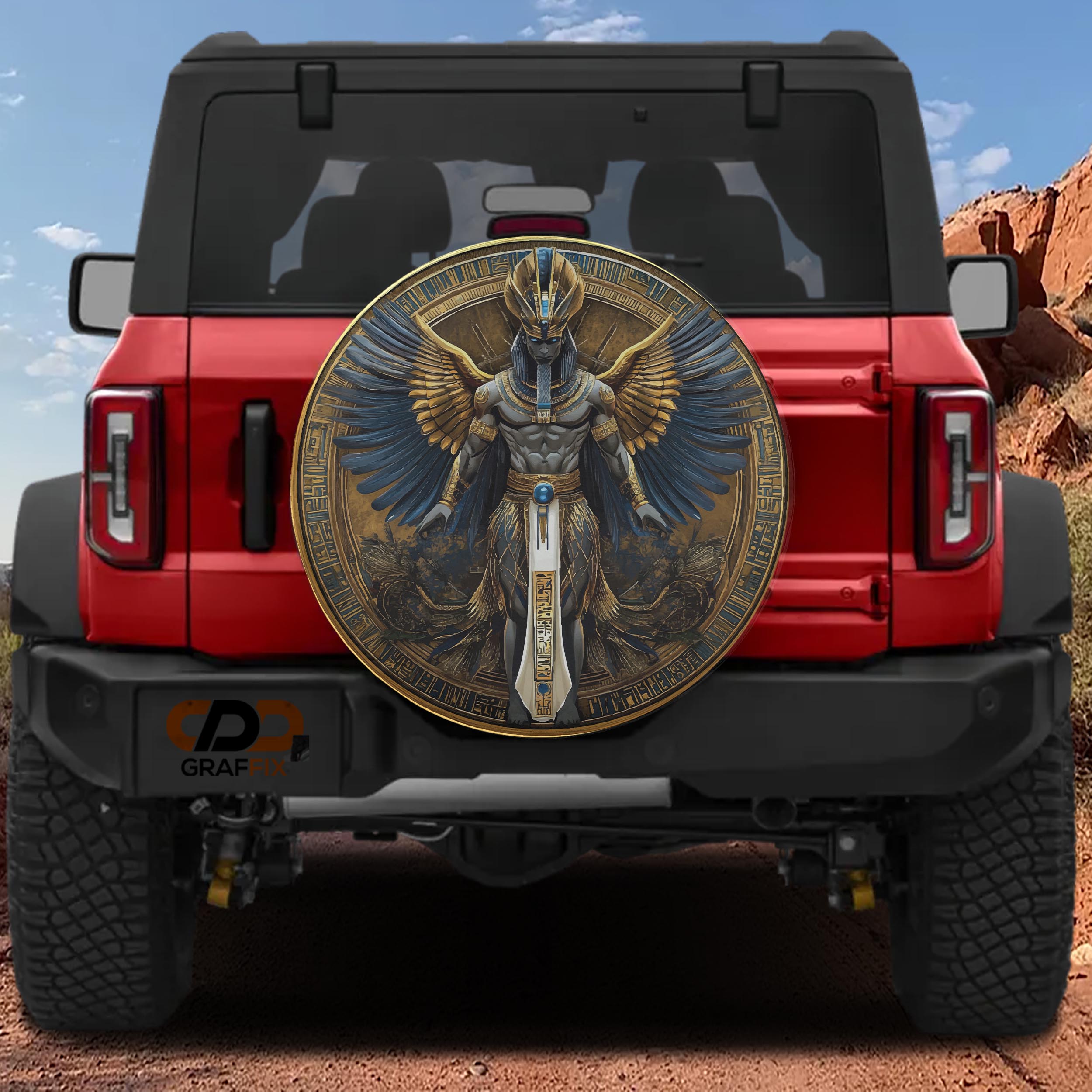 Egyptian pharaoh winged deity spare tire cover on a black Jeep Wrangler showing GRAFFIX rear bumper sticker