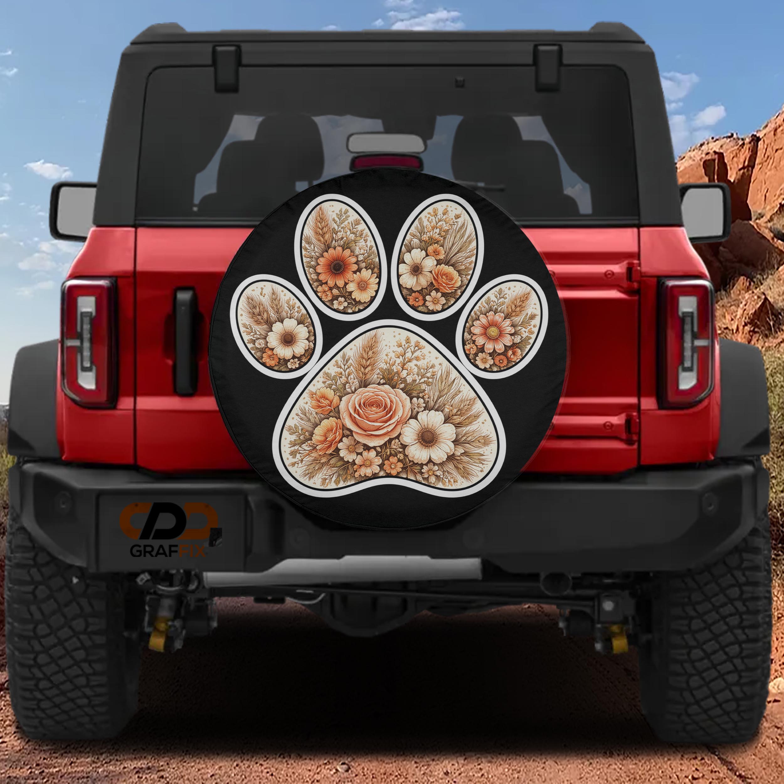 A red Jeep Wrangler with a floral paw print decal on the rear window.