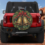 Golden Jingle Bells spare tire cover on a red Jeep Wrangler with wreath bells and red ribbon