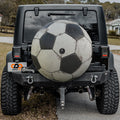 Soccer ball black and white spare tire cover mounted on black Jeep Wrangler rear outdoors