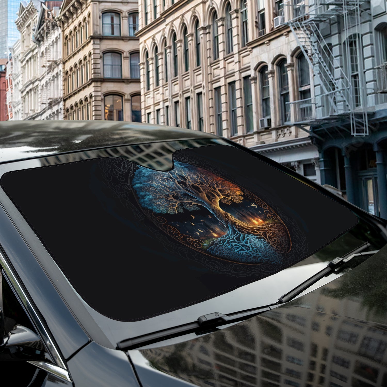 Norse Tree of Life accordion sunshade close-up installed on a dark sedan windshield exterior detail view