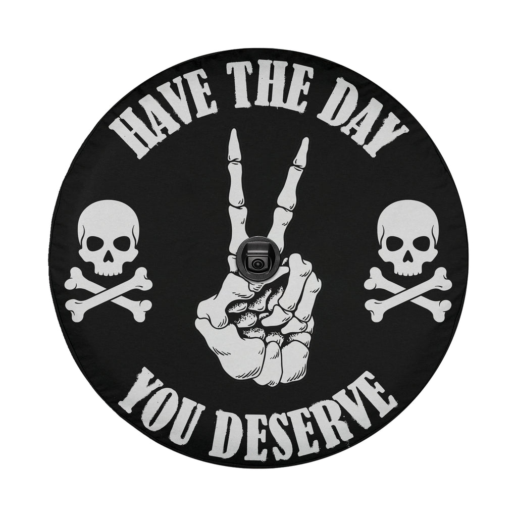 a black and white design with a hand making a peace sign and two skull and crossbones symbols on either side. The text "HAVE THE DAY YOU DESERVE" is displayed around the design.