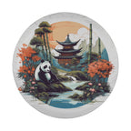 A panda resting on a rock in a serene landscape with a pagoda in the background, surrounded by trees, flowers, and a body of water.
