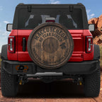 a red Jeep Wrangler with a wooden spare tire attached to the rear.