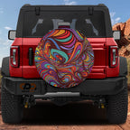 Rainbow psychedelic tire cover standalone product render showing bright orange teal purple swirl design