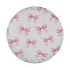 a circular pattern of pink bows on a white background.