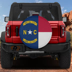 North Carolina state flag spare tire cover on red Ford Bronco with blue red white NC banner