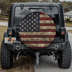 Black Jeep Wrangler with Rustic American Flag spare tire cover installed on rear bumper