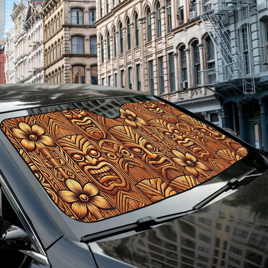 Tribal Tiki woodgrain accordion sunshade installed in a sedan windshield on a sunny city street scene