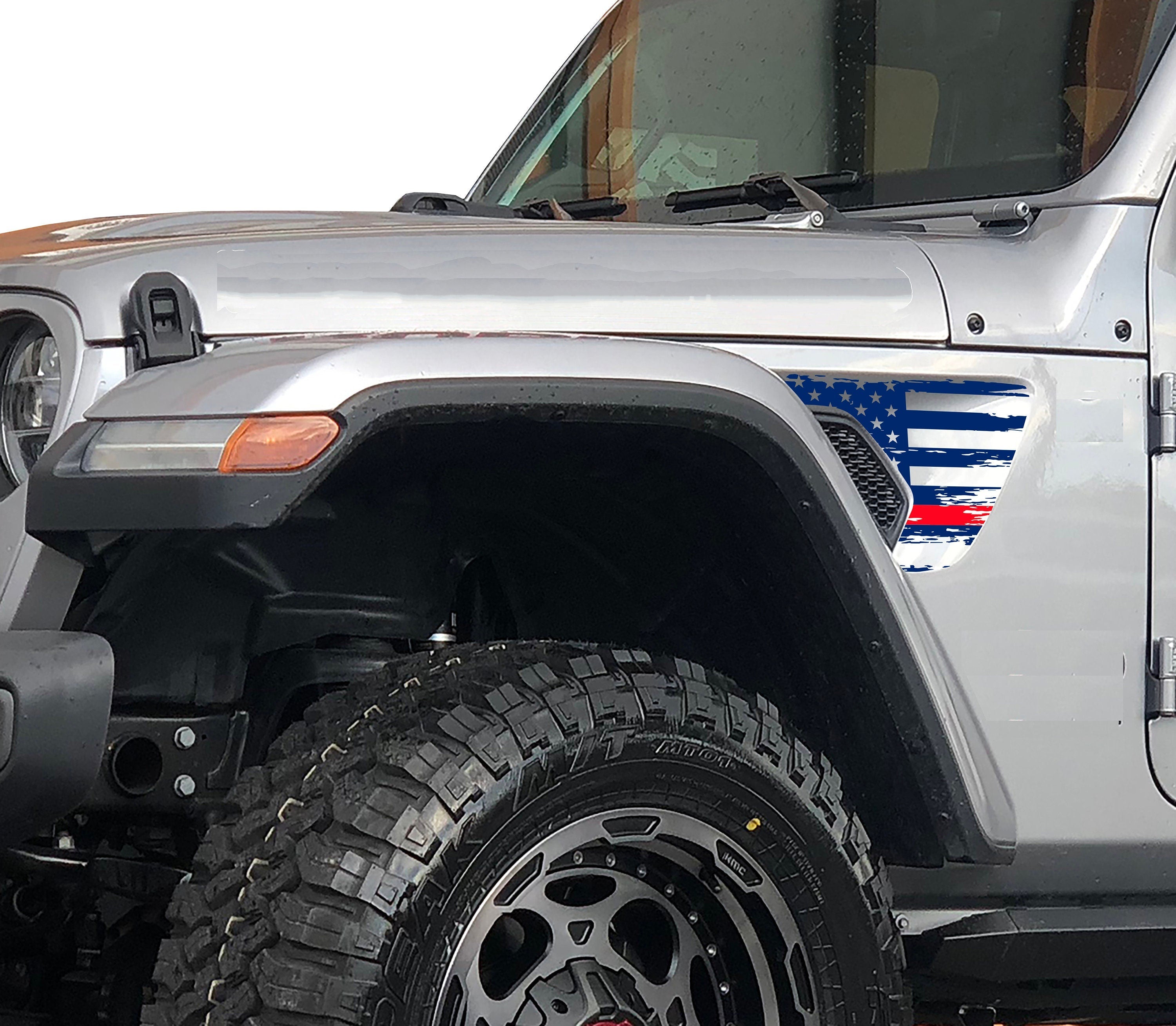 Angled view distressed tattered American flag vinyl decal applied to Jeep Wrangler vent