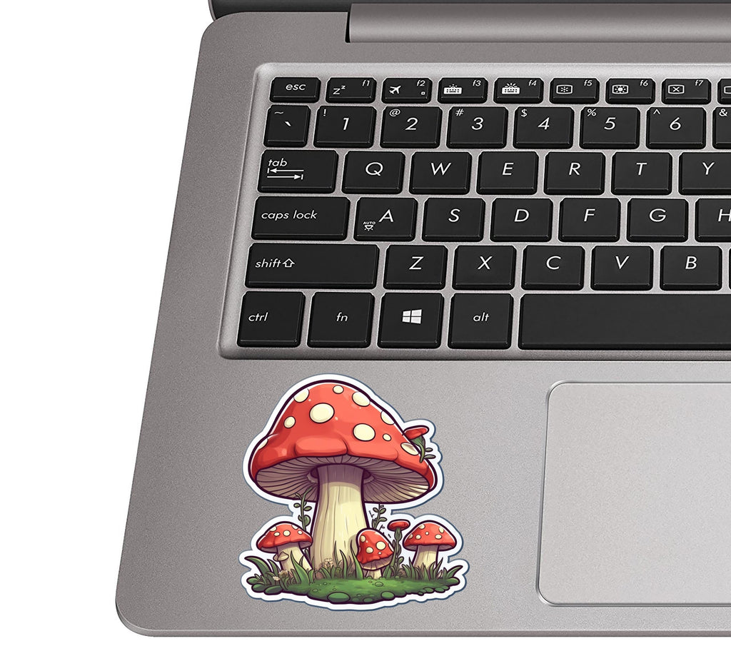 Mushroom patch toadstool sticker on a silver laptop palm rest near a black QWERTY keyboard for size