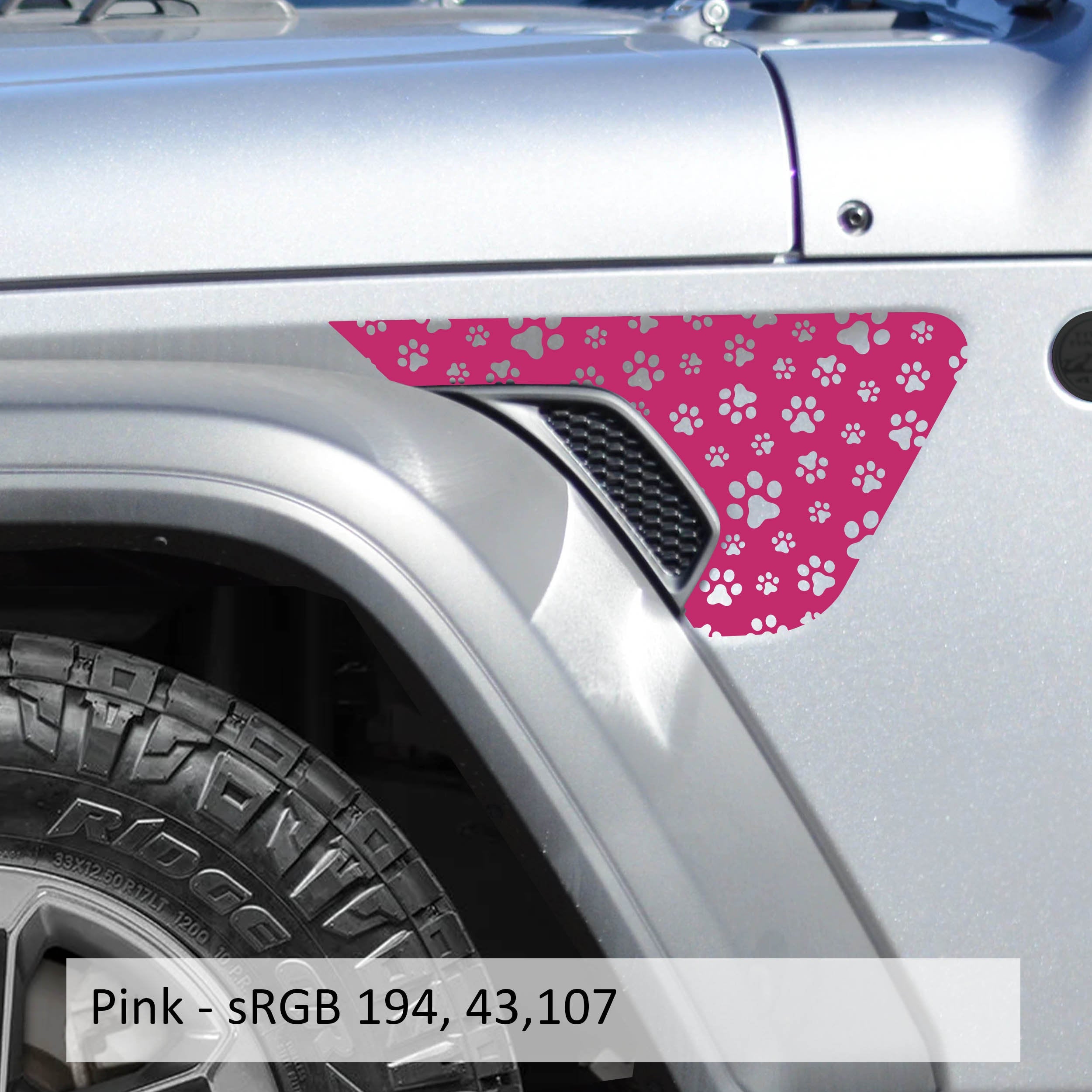 Pink dog paw print pattern fender vent decal shown installed on silver Jeep Wrangler JL fender