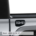 May include: A black truck bed with a black 1941 decal on the side. The truck bed is silver and the decal is in a rounded rectangle shape.