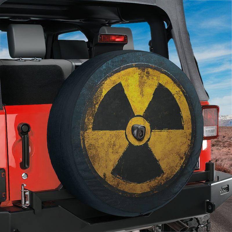 Fallout shelter radiation spare tire cover mounted on a red Ford Bronco tailgate amid red rock desert
