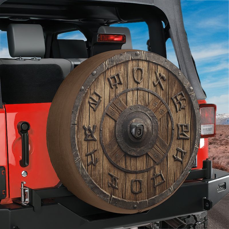 Norse rune wooden shield spare tire cover shown on a black Jeep Wrangler with desert backdrop