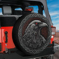 Odin's ravens Huginn and Muninn spare tire cover on a red Jeep Wrangler tailgate with desert mountain scene