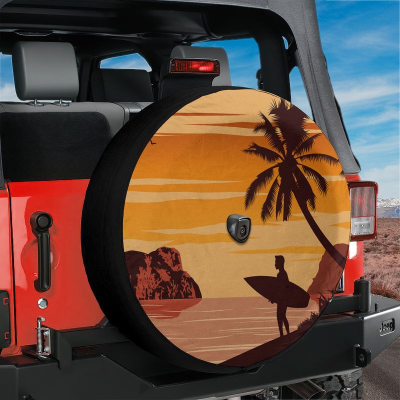 Sunset surfer spare tire cover on red Ford Bronco with palm tree silhouette and surfer holding board at dusk