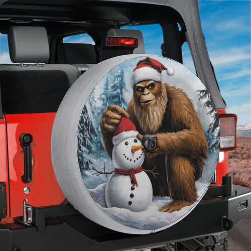 Red Jeep Wrangler showing Bigfoot building snowman spare tire cover with backup camera hole opening
