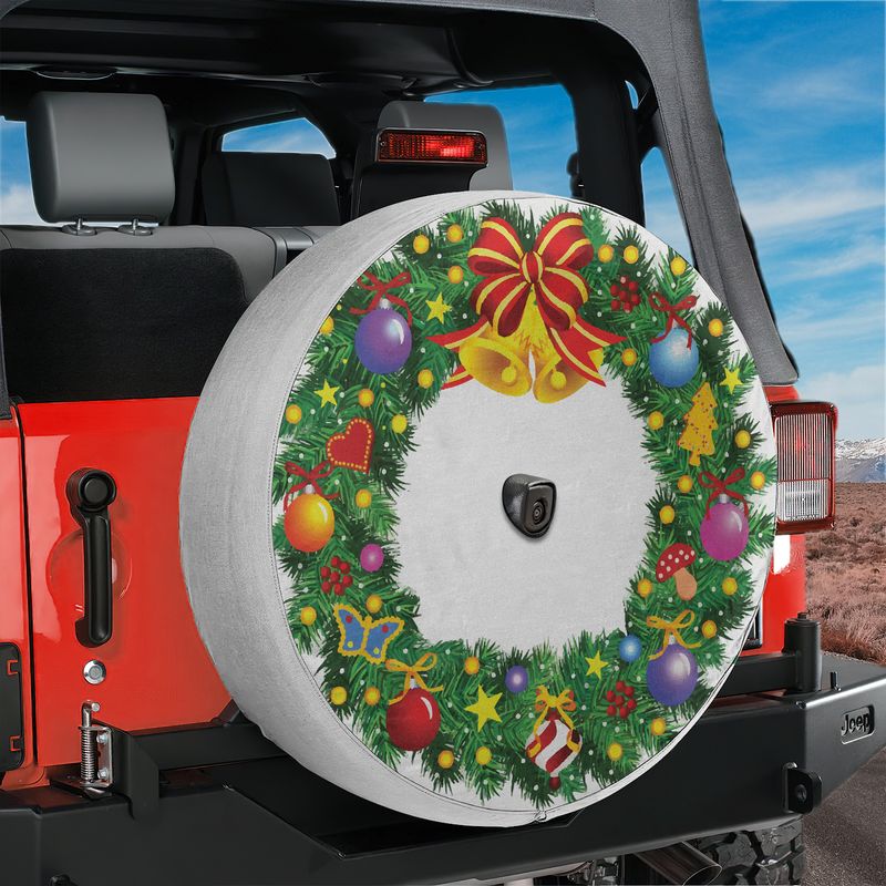 Red Jeep Wrangler displaying festive Christmas wreath spare tire cover with center backup camera cutout