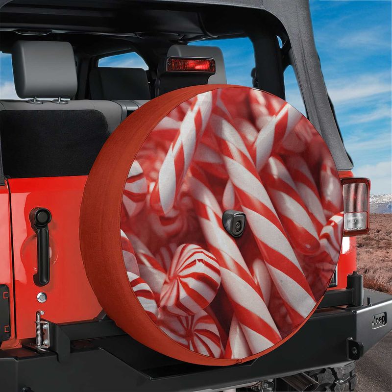 Red Jeep Wrangler spare tire cover showing peppermint candy cane design with rear camera hole