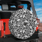 Skull and crossbones tire cover flat round front view with cartoon white skulls and crossed bones on black