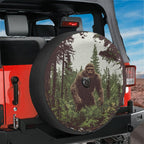 Bigfoot pine forest tire cover on red Jeep Wrangler with backup camera cutout legendary cryptid art