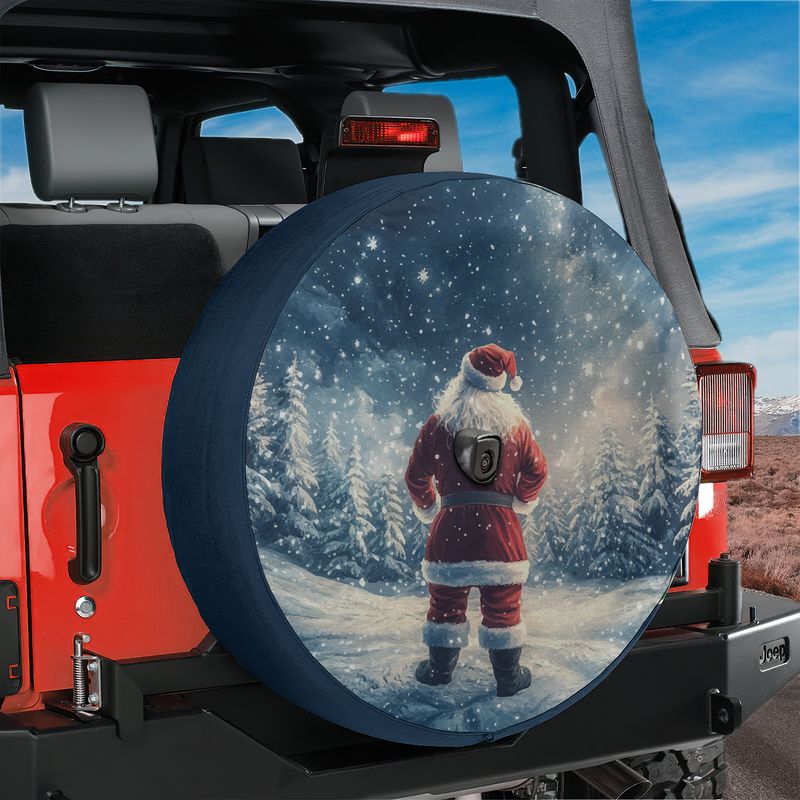 Santa Claus silent night spare tire cover mounted on the rear of a black Jeep Wrangler vehicle
