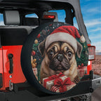 Pug in a red Santa hat surrounded by ornaments tire cover shown on a black Jeep Wrangler tailgate