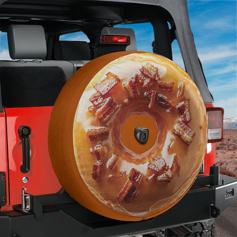 Glazed maple bacon donut tire cover on red Jeep Wrangler with maple glaze and crispy bacon piece toppings