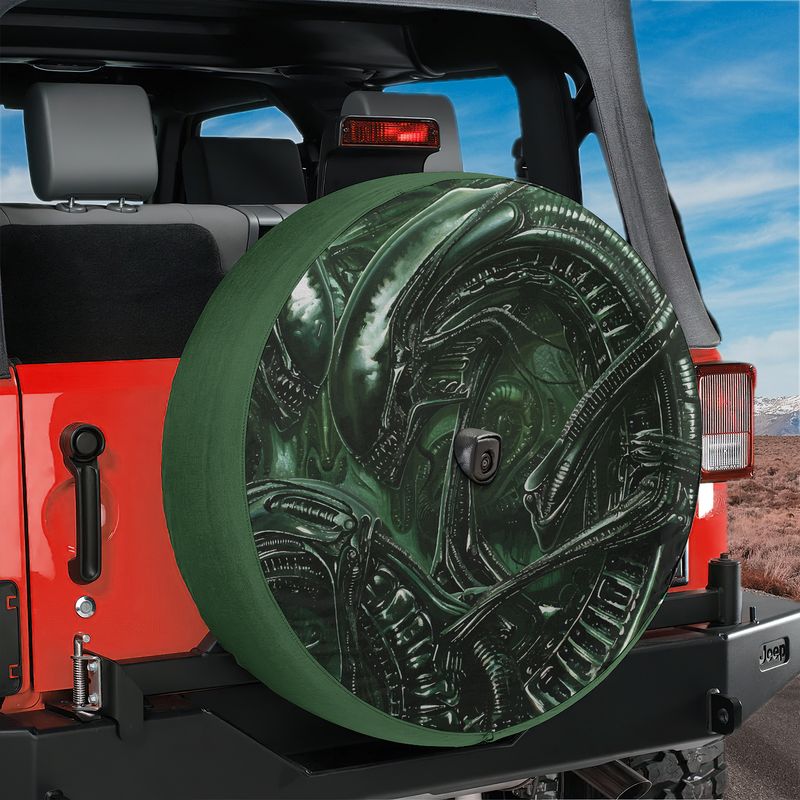 Alien lifeform spare tire cover product mockup on red Ford Bronco rear tailgate desert backdrop scene